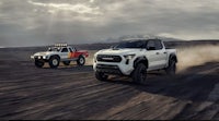 the 2020 toyota tacoma is driving on a dirt road